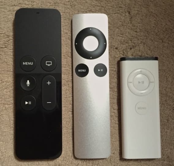 Three generations of Apple TV remotes side by side