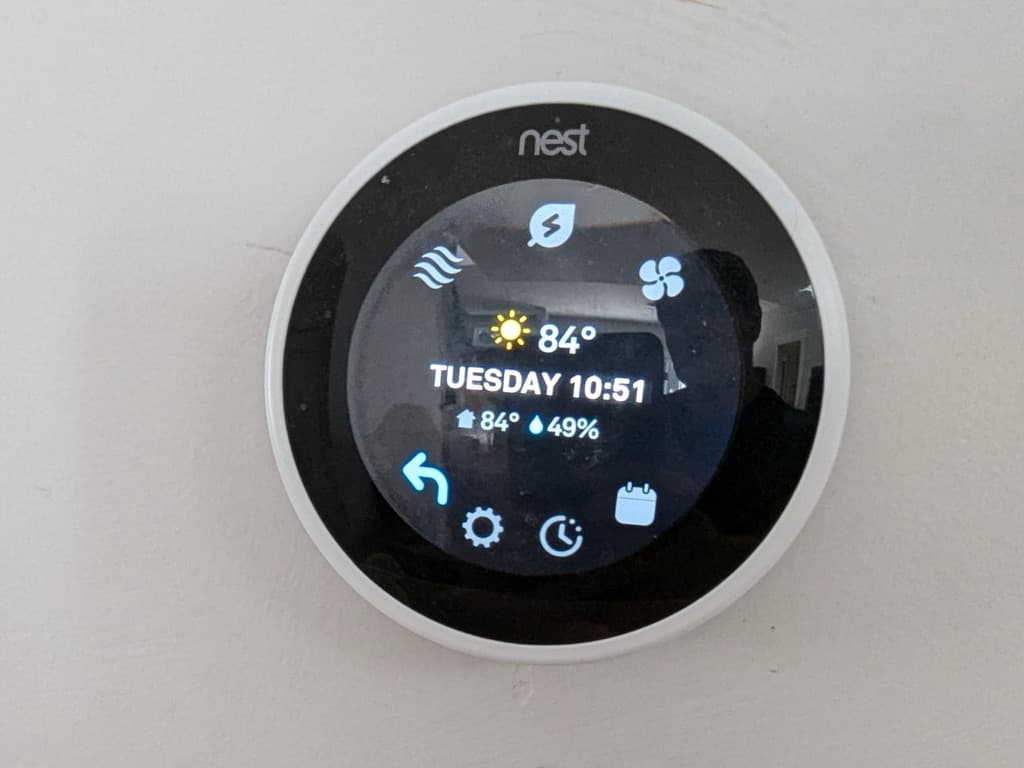 Nest smart thermostat on the wall, connected and working