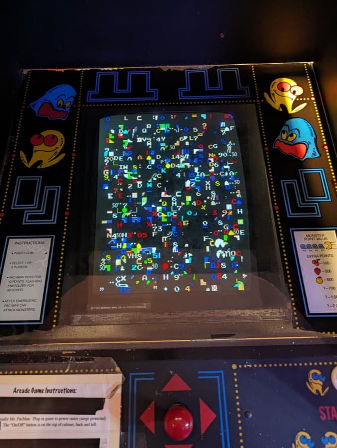 Arcade monitor showing garbled, scrambled video before repair