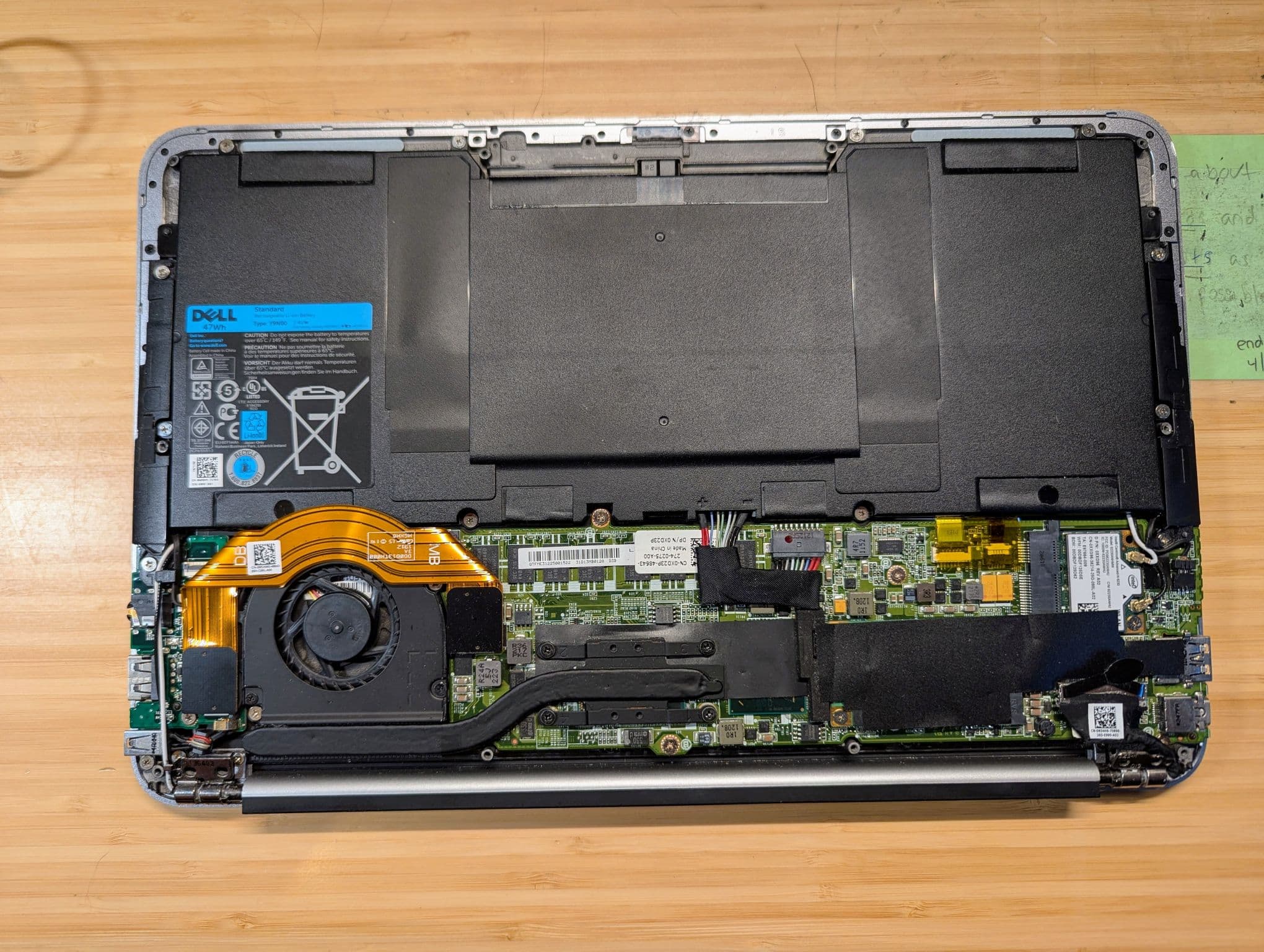 Dell XPS laptop opened on the workbench for a battery replacement